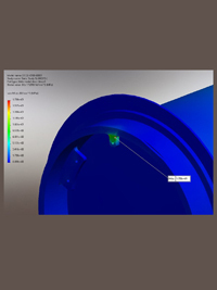 Finite element analysis (FEA) simulation of a blue curved mechanical part, showing a green stress concentration and legend.